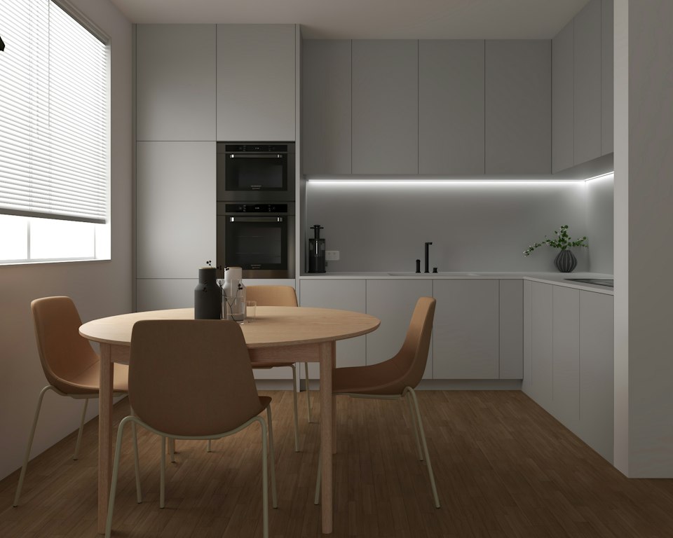 Cocina americana compacta con comedor integrado en un apartamento pequeño